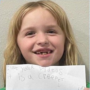 A girl holding a handwritten note